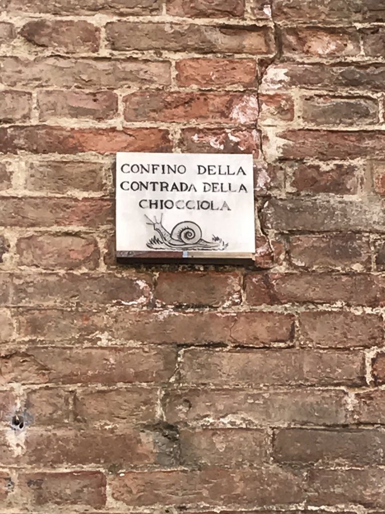 Tile marking the Snail district in Siena